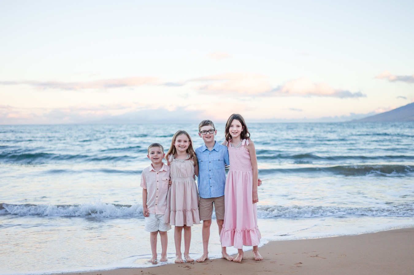 Children enjoying a sunrise mini session on a Maui beach