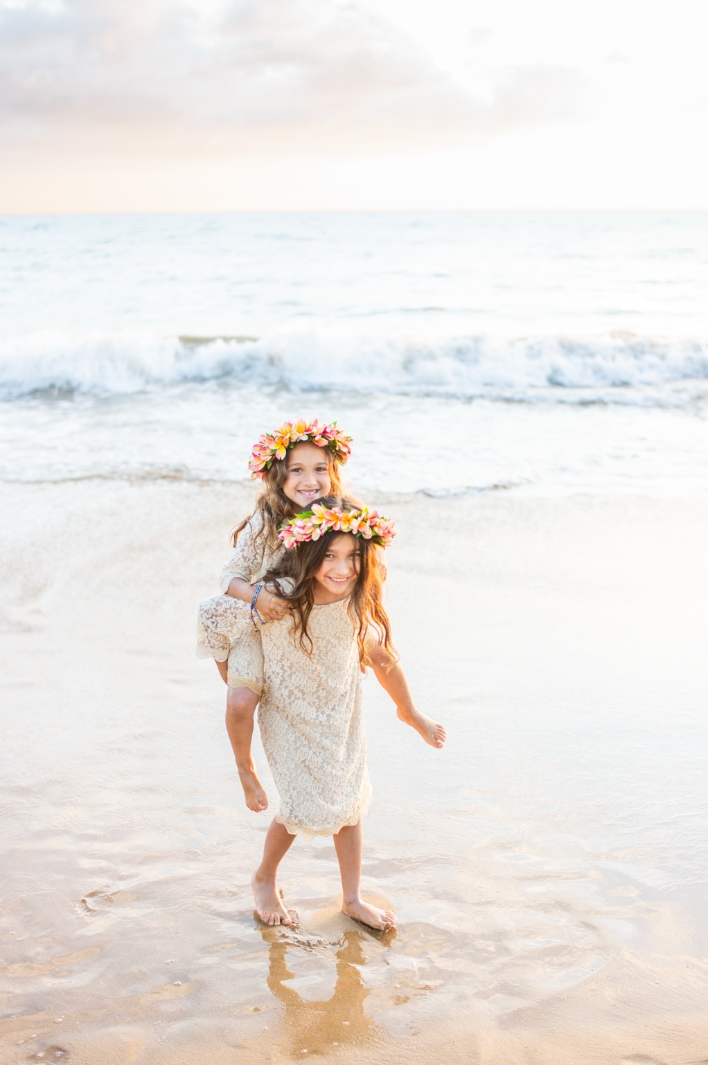 Two girls playing together on a bright Maui beach