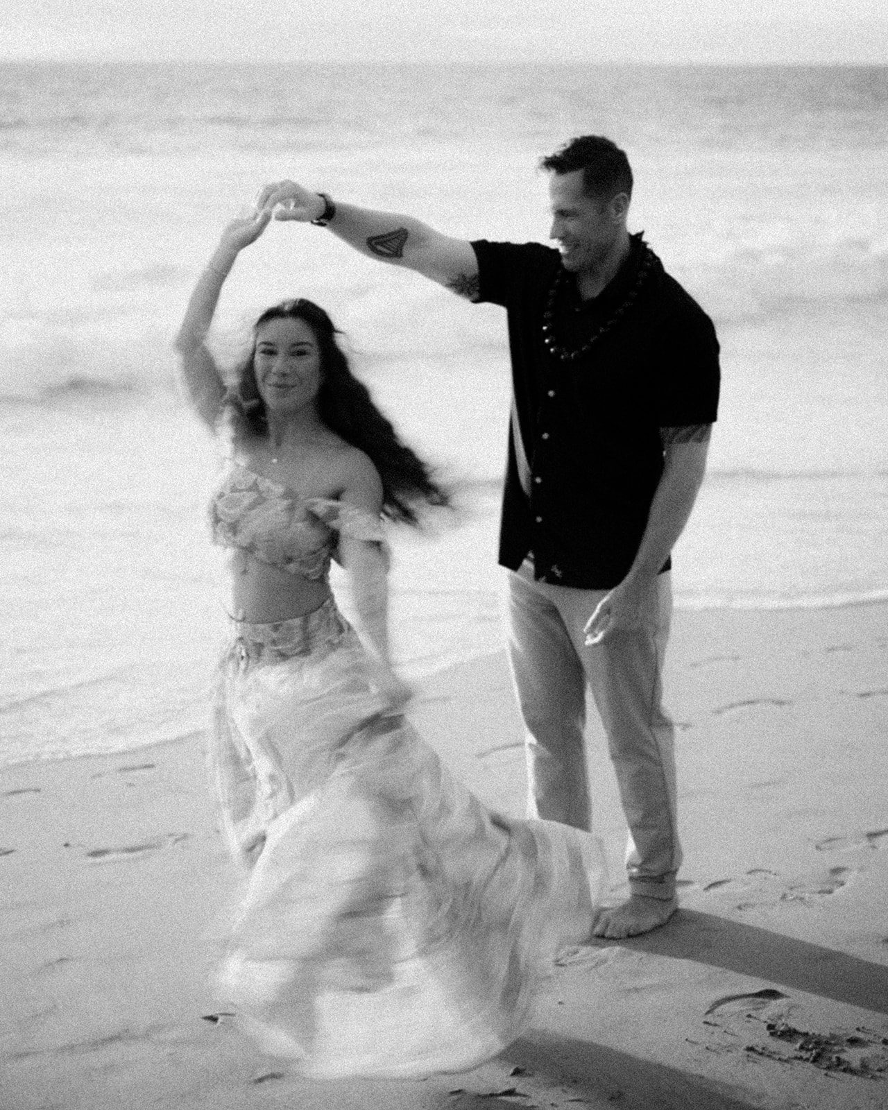 Monica and her partner dancing on the sand at sunset in Maui, photographed by Wailea Photo