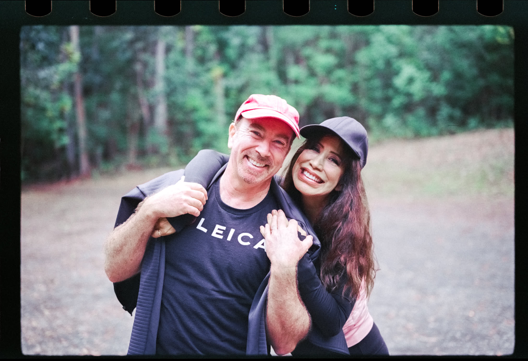 Laurence and Jude Balter hiking together in Maui, with Laurence wearing a Leica shirt