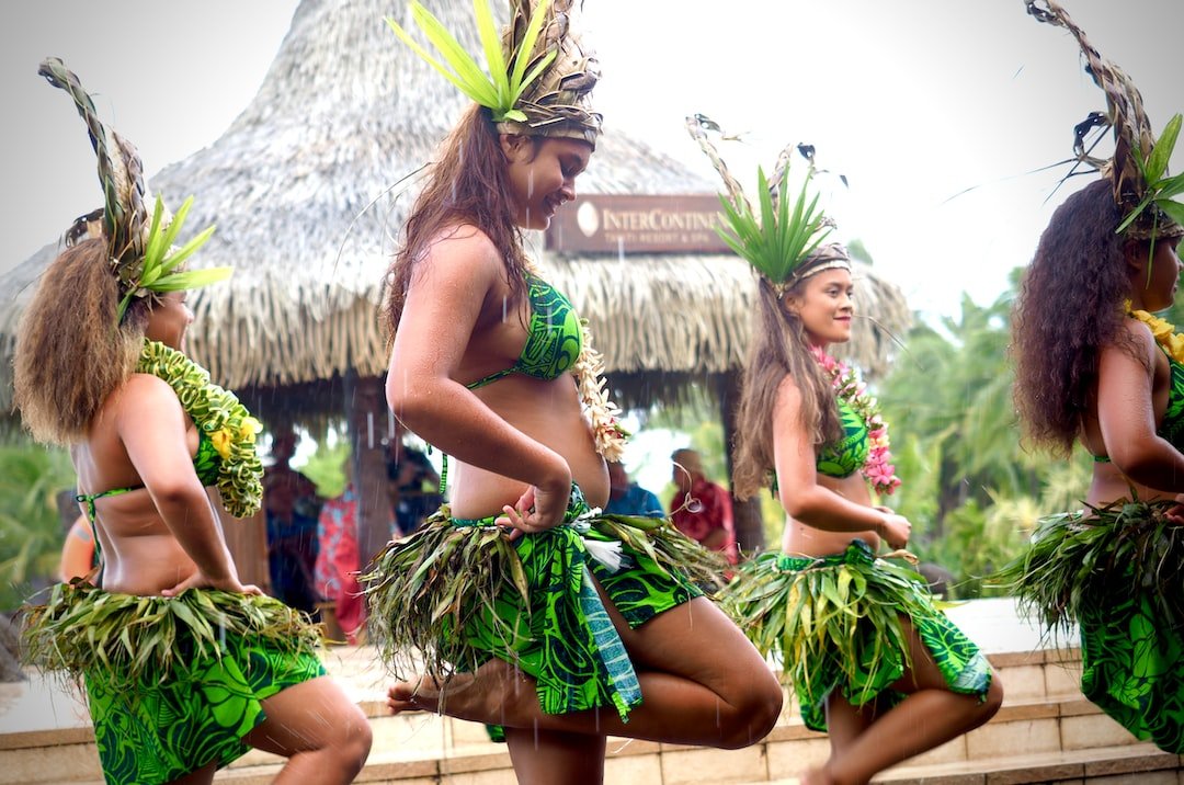 Polynesian dancers performing outdoors during a daytime cultural celebration