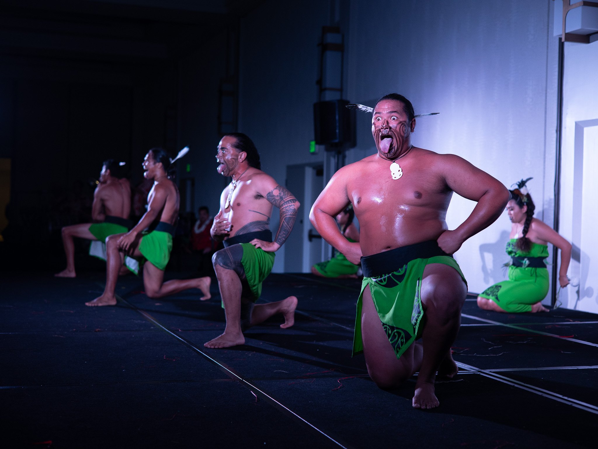 Polynesian cultural performers presenting a powerful warrior dance during a lūʻau