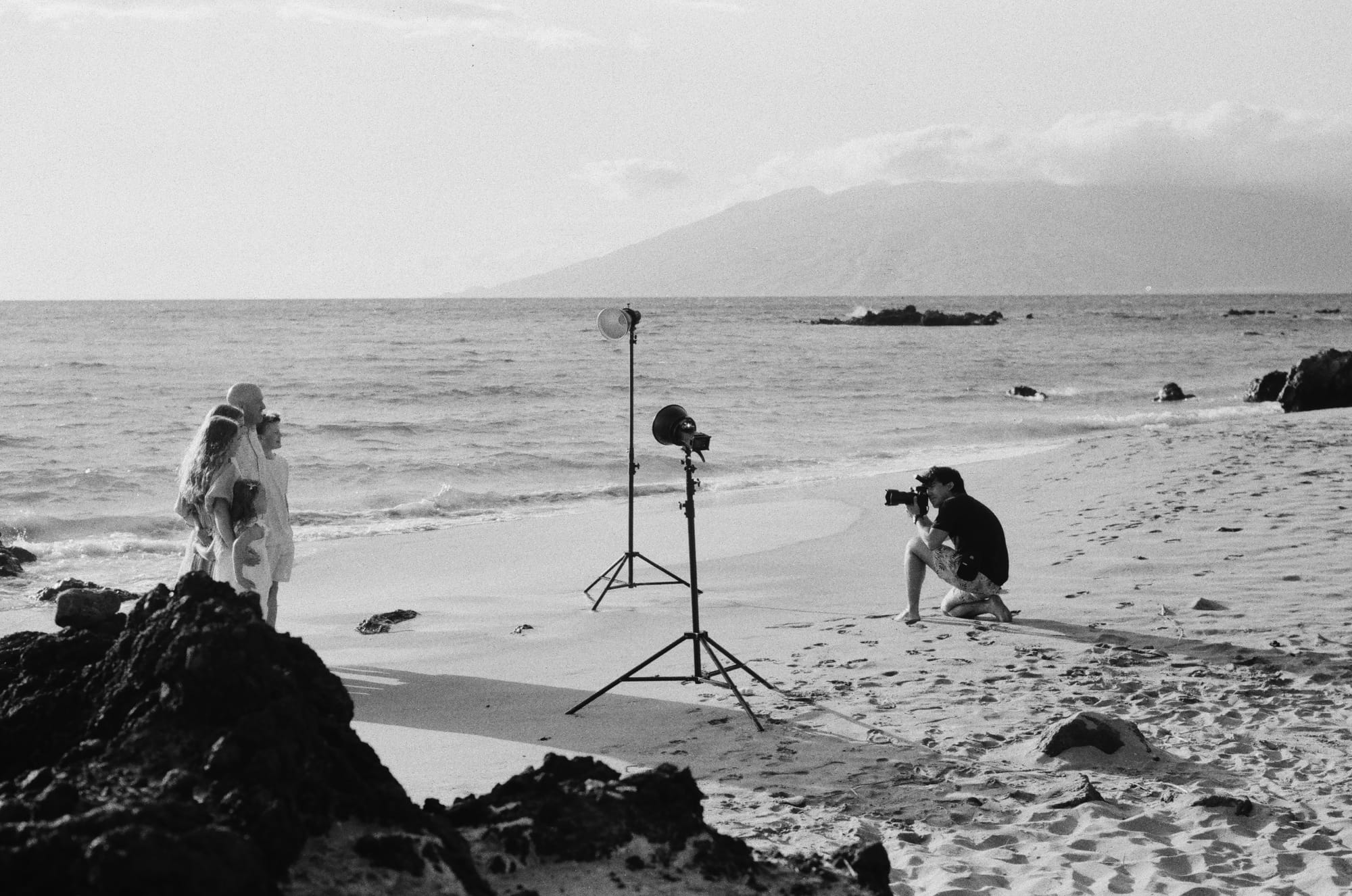 Behind the scenes view of a Wailea Photo family portrait session with professional lighting on Mokapu Beach