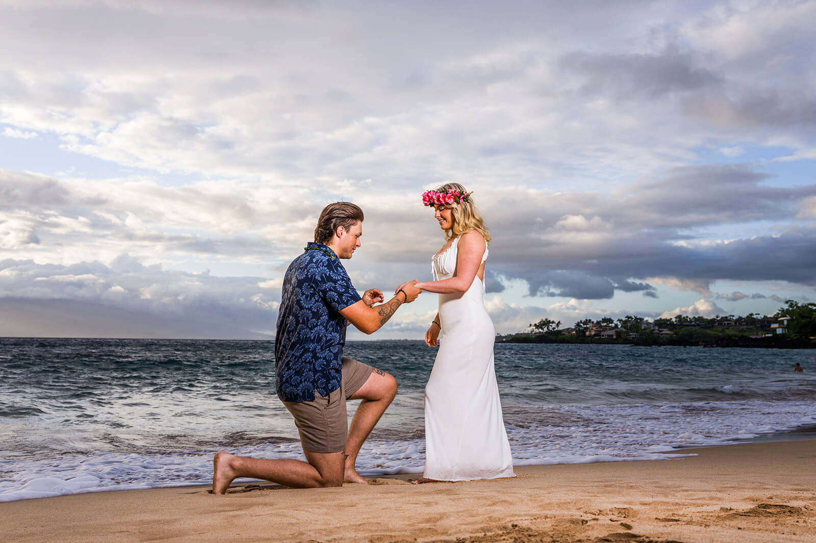 A carefully positioned Maui beach proposal with the engagement ring clearly visible