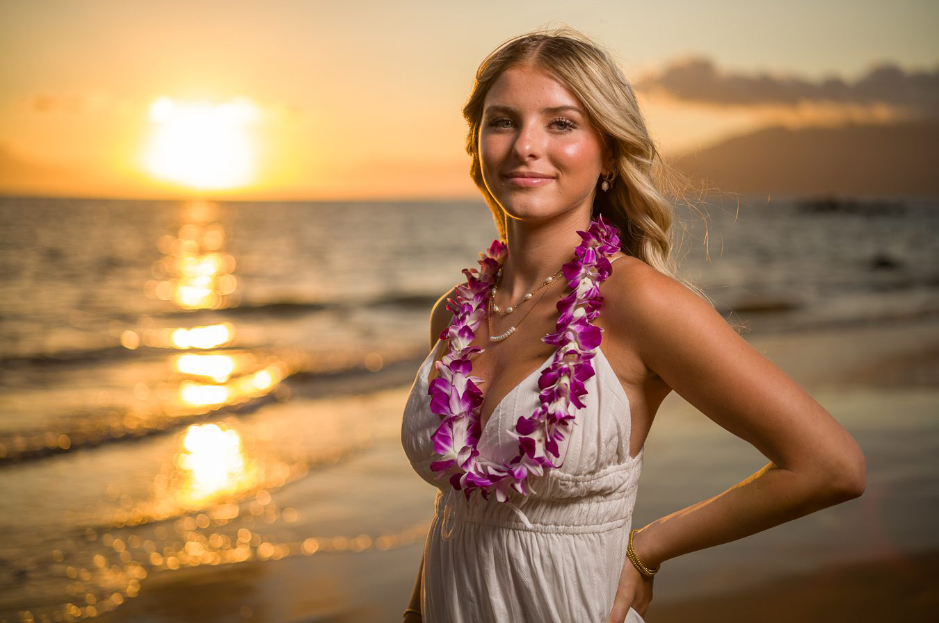 Close-up senior portrait of a graduate wearing a purple orchid lei at sunset in Maui