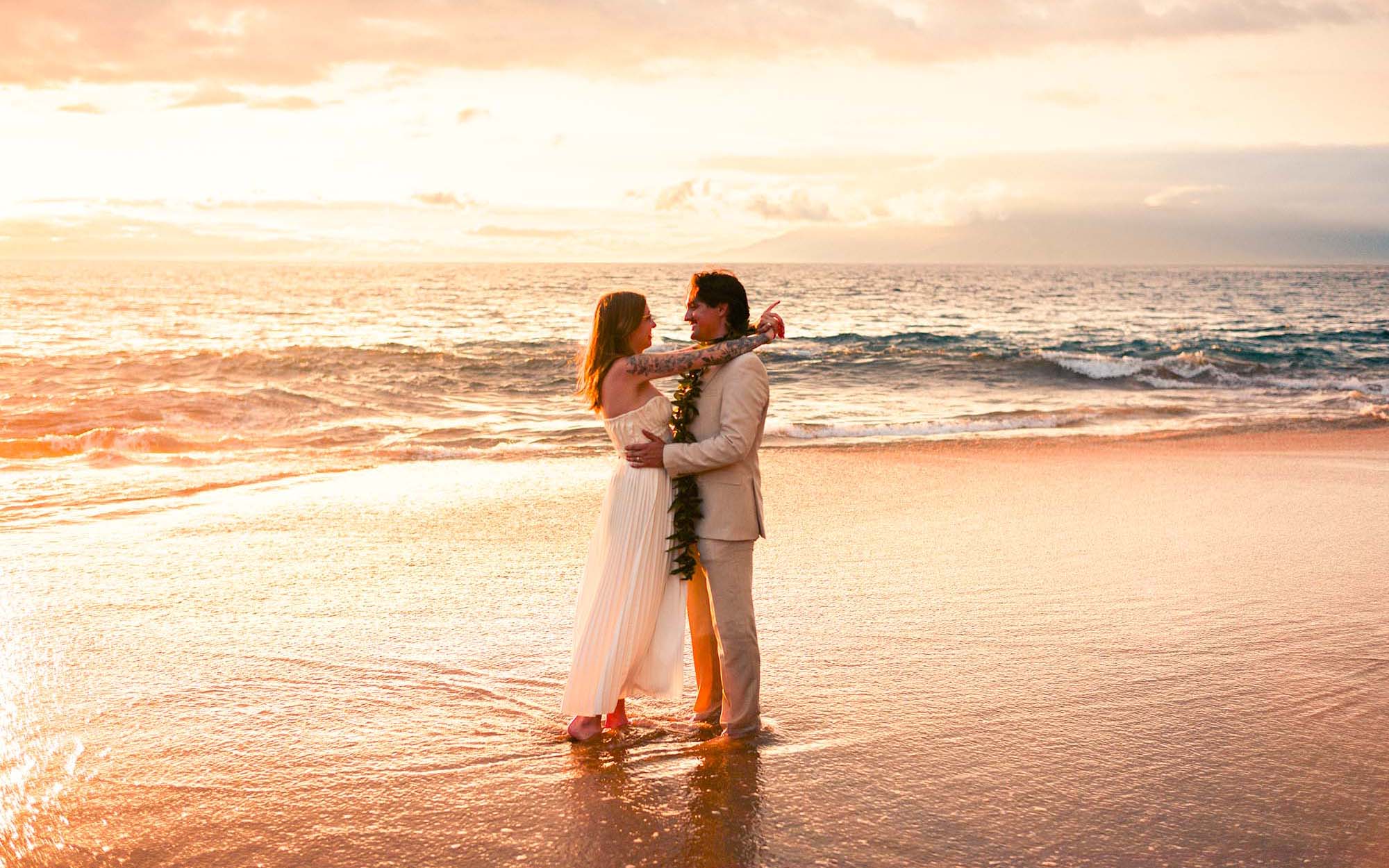 Couple embracing in the surf at golden hour on a Wailea beach, Maui - image by Wailea Photo®
