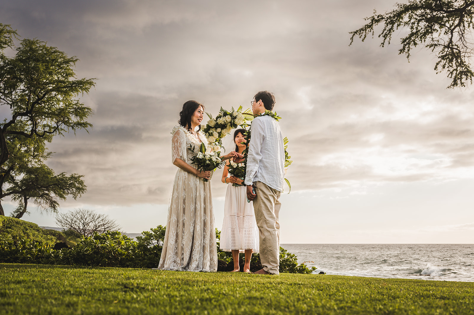 A couple renewing their vows with their daughter in Wailea