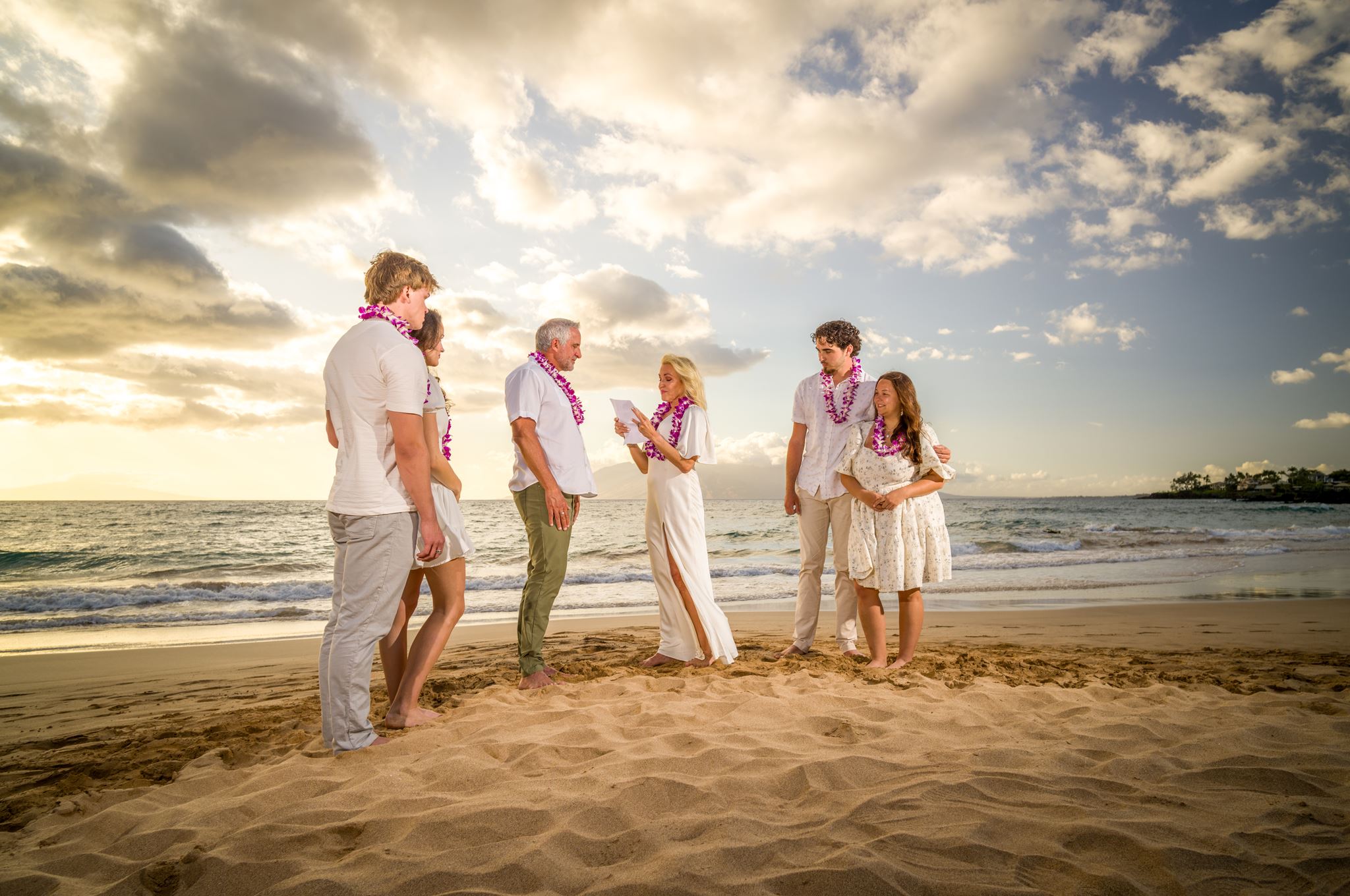A family gathered for a Maui beach vow renewal at sunset