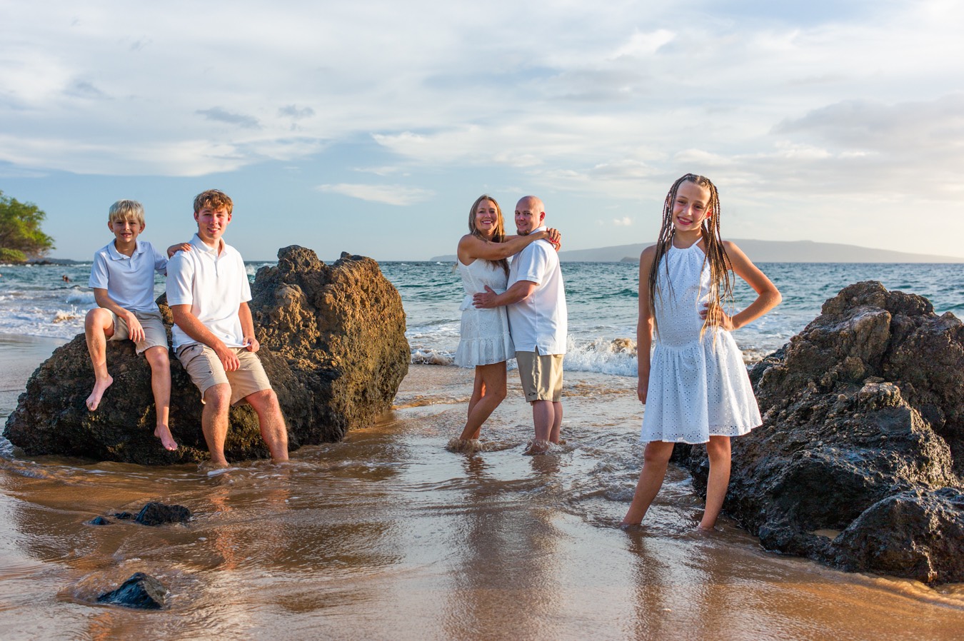 A family photographed on a Wailea beach near the Wailea Beach Resort at sunset