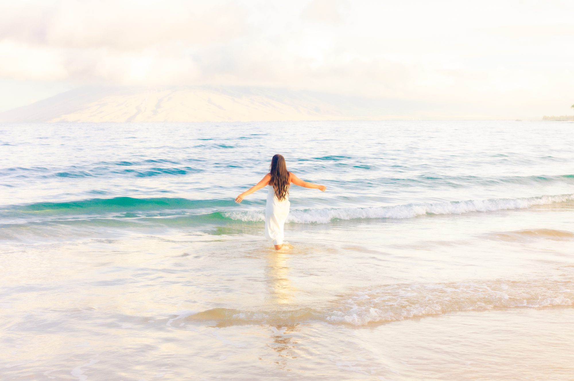 A couple at sunrise on a Maui beach